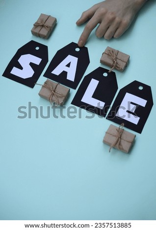 On black tags there is an inscription in white letters, the word is for sale. on a light background