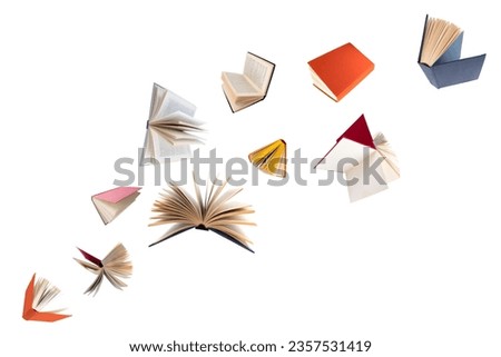 Colorful hardcover books flying on white background