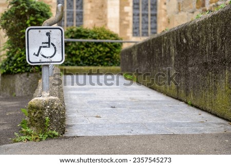 Barrier-free access to the Kornhaus in Kirchheim Teck, Germany via a ramp marked with a sign marked with wheelchair.