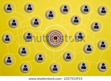 Wooden round target and wooden cubes with figure icon are connected, symbolizing the concept of target audience identification Royalty-Free Stock Photo #2357553915
