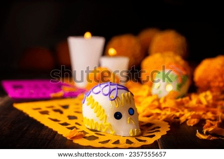 Sugar skull with Candles, Cempasuchil flowers or Marigold and Papel Picado. Decoration traditionally used in altars for the celebration of the day of the dead in Mexico Royalty-Free Stock Photo #2357555657