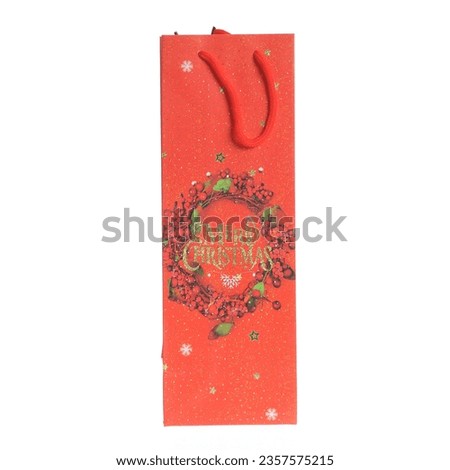 paper gift bag with winter holiday decoration isolated on white background
