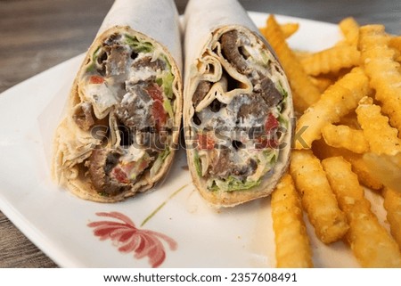 Gyro with Golden French Fries Royalty-Free Stock Photo #2357608491