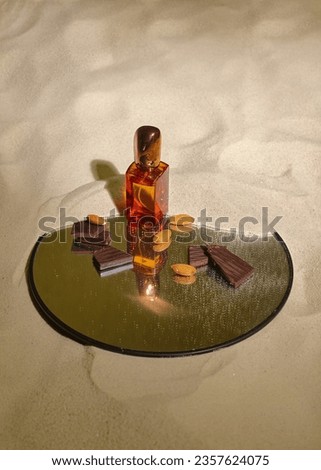 glass perfume bottle with almond and chocolate aroma on a neutral background