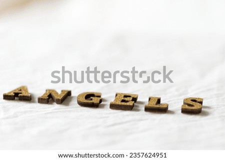 close-up of the word "angels" on blank soft fabric background
