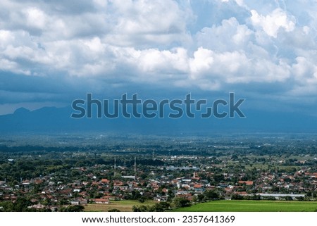 beautiful view of the city under the mountains.  as well as added extensive rice fields.  This place is located in Klaten, Central Java, Indonesia.