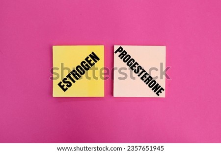 colored paper with the words estrogen and progesterone. concept of female hormones and menopause Royalty-Free Stock Photo #2357651945