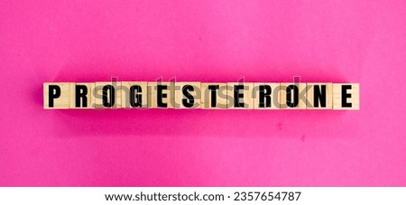 wooden cube with the word progesterone. Progesterone is an endogenous steroid hormone that is commonly produced. female hormone concept Royalty-Free Stock Photo #2357654787