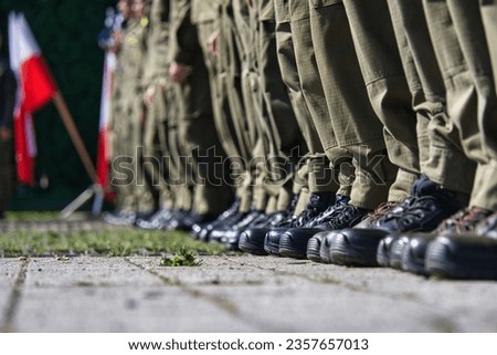 Military boots on the legs of soldiers in a row.