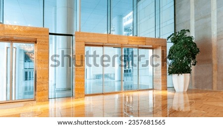Modern office building with glass doors and wall
 Royalty-Free Stock Photo #2357681565