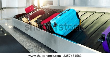 Group of suitcases on conveyor belt in airport Royalty-Free Stock Photo #2357681583