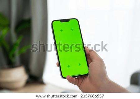 Closeup of smartphone woth mockup greenscreen in man's hands. Online shopping,delivery,social media etc 