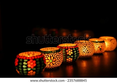 Diwali celebration Indian festival of lights Diya oil lamp lantern. Colors Rangoli decoration colorful flowers flowerbed copy space. Greetings Deepavali Hindu festival North India Mumbai Delhi India. Royalty-Free Stock Photo #2357688845