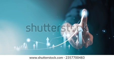 investment and finance concept, businessman holding virtual trading graph and blurred light on hand, stock market, profits and business growth. Royalty-Free Stock Photo #2357700483
