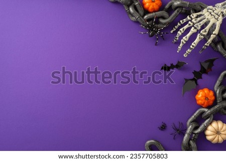 Thrilling Halloween party inspiration. High-angle image showcasing pumpkins, paper bats, chains and Halloween-themed embellishments on a purple isolated backdrop. Perfect for text or advertising use
