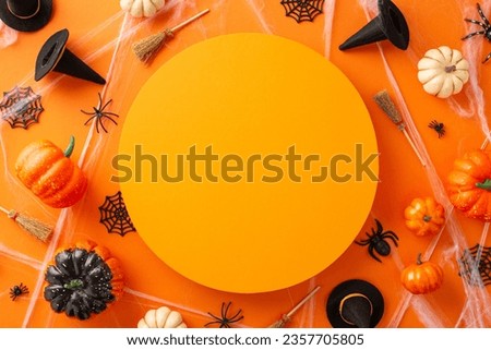 Vibrant Halloween celebration vision. Bird's-eye view image featuring pumpkins, witch hats and brooms and Halloween-themed elements on isolated orange surface with space for text or marketing use