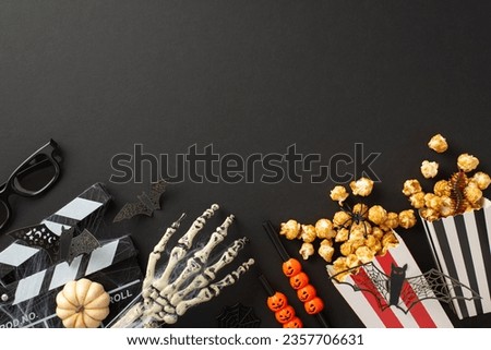 Dive into night of frights and scares with a captivating aerial shot of movie popcorn, glasses and clapper adorned with Halloween accents on an isolated black background, perfect for your text or ads