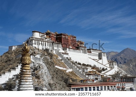 Timeless view of Potala Palace from Chagpori, Lhasa, Tibet, bathed in golden sunset hues against the Himalayan backdrop.