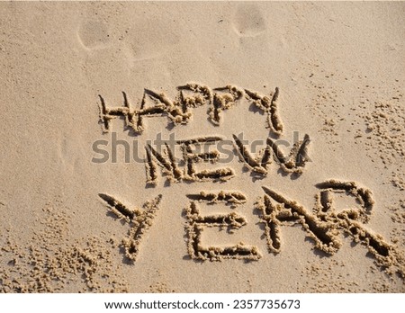 Words "Happy New Year" Written in Beach Sand
