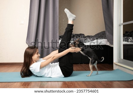 Teenager and pet dog engaging in healthy yoga activities