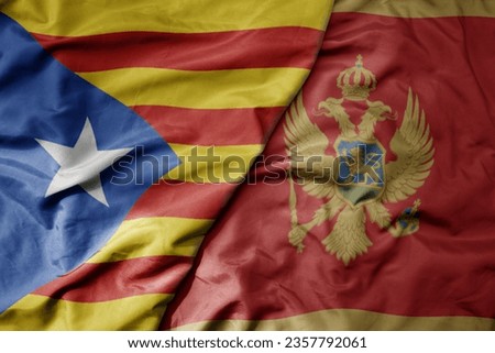 big waving national colorful flag of catalonia and national flag of montenegro . macro