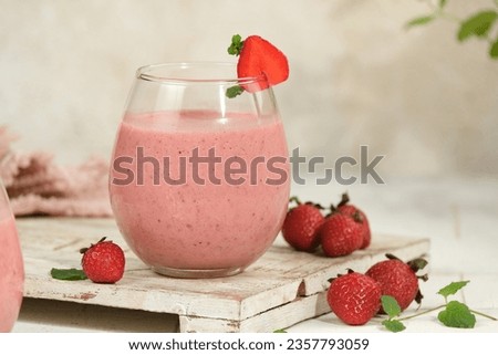Strawberry smoothie or milkshake with berries and mint on white background Royalty-Free Stock Photo #2357793059