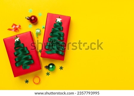 Creative handmade christmas gift boxes with decor on color background, top view