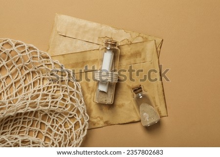 Columbus Day. Old envelopes and a glass bottle with a letter inside