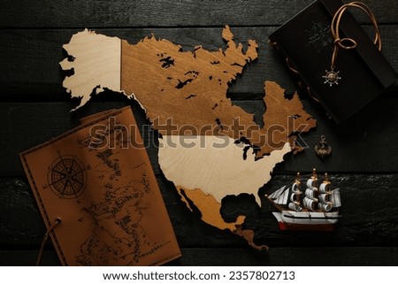Columbus Day. A wooden model of America with a notebook and a ship