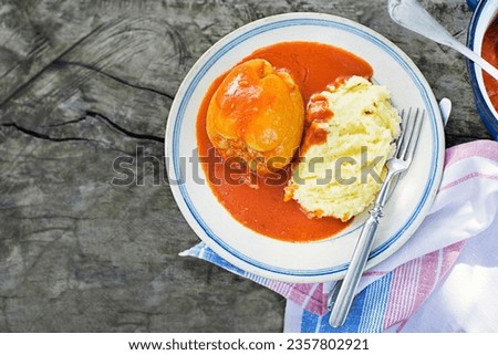 Stuffed peppers with ground meat and rice in tomato sauce with mashed potatoes. European traditional dish cuisine Royalty-Free Stock Photo #2357802921