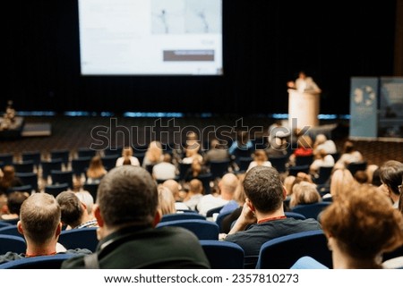 Speaker giving a talk on scientific conference. Audience at the conference hall. Business and Entrepreneurship concept Royalty-Free Stock Photo #2357810273