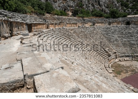 The ruins of the amphitheater and ancient rock tombs in the ancient city of Myra in Demre, Turkey Royalty-Free Stock Photo #2357811083