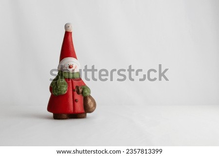 Christmas decoration figure, snowman, snowman leaving space for text, with red hat and jacket, green scarf, figure on plain background, perfect for designer editions