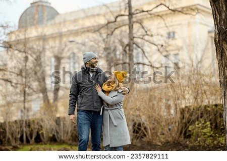 Embraced romantic couple enjoying a walk in the park