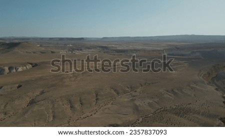 Negev Desert, Israel. Aerial photography by drone. Shooting at sunset, near David and Paula Ben Gurion gravesite. Panoramic desert landscape over mountains, sandy hills and rock formations.