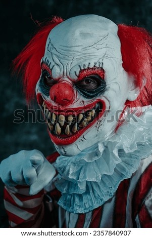 a mad evil redhead clown, wearing a costume with a white ruff, is pointing to the observer with a creepy smile, on a dark background