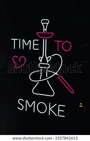 Neon sign on a black background, white pink text Time to smoke and image of a hookah