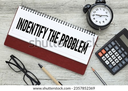 Identify the problem text on the page on the diary. a table clock. glasses Royalty-Free Stock Photo #2357852369