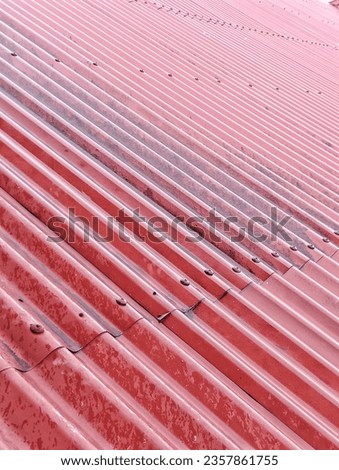 the red roof of the house was wet after it rained in the afternoon