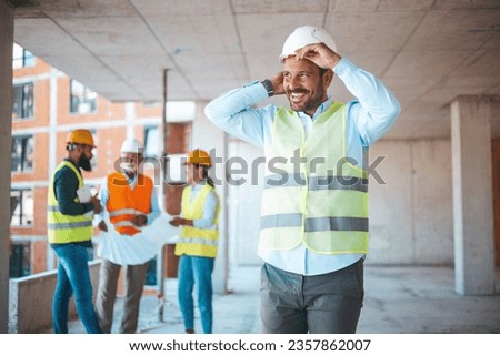 Portrait of man architect at building site. Confident construction manager in formal clothing wearing white hardhat. Successful civil engineer at construction site with copy space. Royalty-Free Stock Photo #2357862007