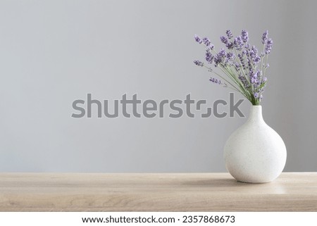 lavender flowers in ceramic vase on gray background Royalty-Free Stock Photo #2357868673