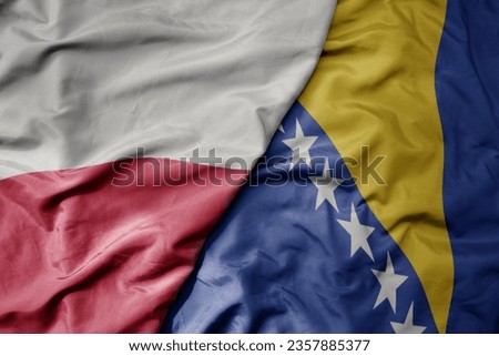 big waving national colorful flag of poland and national flag of bosnia and herzegovina . macro