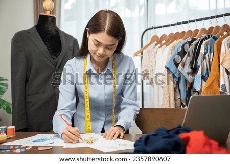 Fashion designer is sketching a model of a dress.