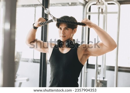 Asian Fitness Male Pull Exercises for Chest and Shoulder Muscle Strength Training in Sport Club Royalty-Free Stock Photo #2357904353