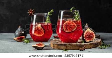 Autumn or winter fig cocktail in glass with thyme. Long banner format.