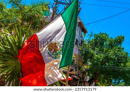 Mexican green white red flag with blue sky tourist people coast caribbean beach and  palm trees in Playa del Carmen Quintana Roo Mexico.