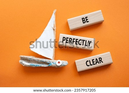 Be perfectly clear symbol. Concept words Be perfectlyclear on wooden blocks. Beautiful orange background with boat. Business and Be perfectly clear concept. Copy space Royalty-Free Stock Photo #2357917205