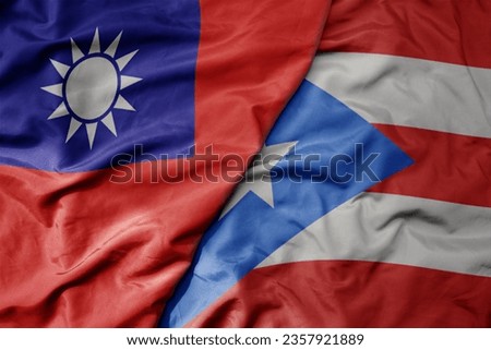 big waving national colorful flag of taiwan and national flag of puerto rico . macro