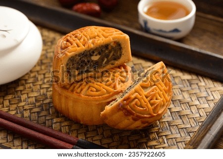 Mid-Autumn Festival mooncakes on a retro background. The Chinese meaning on the mooncakes in the picture is: black sesame, representing the taste of mooncakes