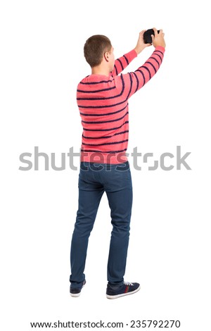 Male tourist taking a photo with camera isolated on white background, rear view